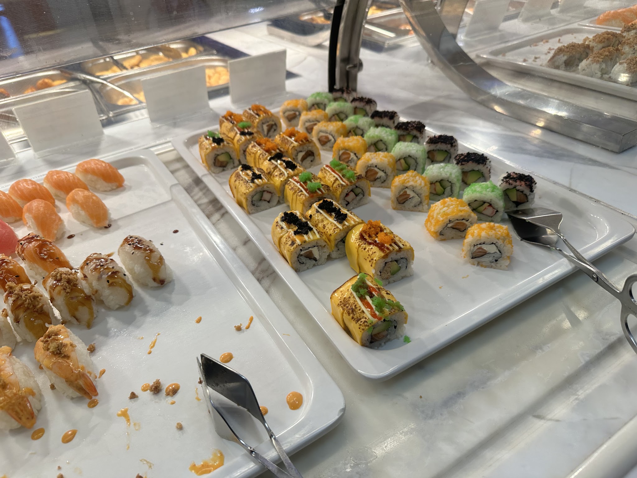 Sushi arranged on serving trays at a buffet